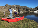 The researchers built a simple pontoon. They rode the boat into the middle of isolated lakes to collect samples of lake-bottom mud, which holds clues about the history of precipitation in a region. Credit: Elizabeth Thomas
