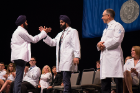 After receiving his white coat from his brother, Dr. Harpartap Singh, Saarang Singh (left) exchanges a high-five with his older brother.