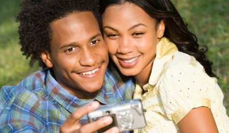 Smiling African American couple taking a selfie. 