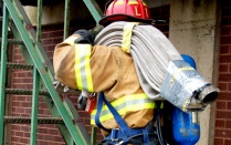 Zoom image: firefighter climbing escape staircase