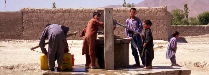 Children collecting water from a well. 