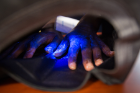 A black light shows the germs that remain on this camper's hands, despite handwashing. Photo: Meredith Forrest Kulwicki