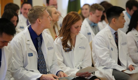 Students in their white coats. 